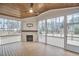 Inviting sunroom with a wood ceiling, fireplace, and panoramic views of the backyard at 240 Seaforth Landing Dr, Pittsboro, NC 27312