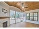 Relaxing sunroom with a fireplace and plenty of windows to enjoy the outdoor scenery at 240 Seaforth Landing Dr, Pittsboro, NC 27312