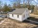 Rear aerial view of a home showing new roof, siding, and refreshed landscaping at 2504 E East Geer St, Durham, NC 27704