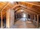 Large attic space with exposed wood beams and a window for natural light at 2504 E East Geer St, Durham, NC 27704