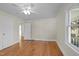 Bedroom featuring hardwood floors, a ceiling fan, and a bright window at 2504 E East Geer St, Durham, NC 27704