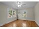 A serene bedroom featuring beautiful hardwood floors and two windows with a view of the outdoors at 2504 E East Geer St, Durham, NC 27704
