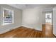 Cozy bedroom with hardwood floors, a ceiling fan, and a glimpse into the adjacent room at 2504 E East Geer St, Durham, NC 27704