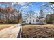 A home featuring a concrete driveway, front porch and traditional architectural details at 2504 E East Geer St, Durham, NC 27704