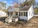 Charming home featuring a cozy front porch and well-maintained landscaping at 2504 E East Geer St, Durham, NC 27704