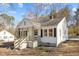Exterior featuring a charming front porch and black shuttered windows on a sunny day at 2504 E East Geer St, Durham, NC 27704