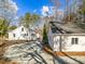 A nice view of the back of the house, showing an outbuilding, and a lot of mature trees at 2504 E East Geer St, Durham, NC 27704