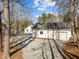 A detached outbuilding with a garage door, pedestrian door, and pea gravel area at 2504 E East Geer St, Durham, NC 27704