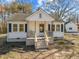 Inviting home features a quaint porch, updated concrete stairs, and well-lit windows at 2504 E East Geer St, Durham, NC 27704
