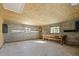 Unfinished garage interior featuring concrete block walls, a workbench, and natural light at 2504 E East Geer St, Durham, NC 27704