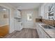 The kitchen features white appliances, countertops with tile backsplash, and luxury vinyl floors at 2504 E East Geer St, Durham, NC 27704