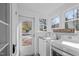 Bright laundry room with appliances, a 