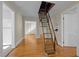 Spacious living area featuring hardwood floors and an attic access ladder at 2504 E East Geer St, Durham, NC 27704
