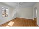 Bright living room with hardwood floors, ceiling fan, and lots of natural light from the large window at 2504 E East Geer St, Durham, NC 27704