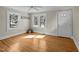Bright living room with hardwood floors, a ceiling fan, and lots of natural light from the windows at 2504 E East Geer St, Durham, NC 27704