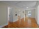 Open living room area featuring beautiful hardwood floors and neutral paint, creating a bright and welcoming space at 2504 E East Geer St, Durham, NC 27704