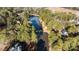 Aerial view of a home in a private, wooded community with lake access surrounded by lush greenery at 2600 Buckingham Dr, Sanford, NC 27330