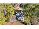 Aerial view of a beautiful home with lush trees, a private pond, and manicured landscaping at 2600 Buckingham Dr, Sanford, NC 27330