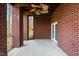 Outdoor porch featuring brick columns, a ceiling fan, and view of the natural surroundings at 2600 Buckingham Dr, Sanford, NC 27330
