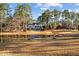 Expansive backyard featuring a serene pond and lush greenery, perfect for relaxation and outdoor activities at 2600 Buckingham Dr, Sanford, NC 27330