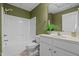 Well-lit bathroom with a shower-tub combo, white vanity, and decorative accents at 2600 Buckingham Dr, Sanford, NC 27330