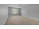 Spacious bedroom with neutral carpet, ceiling fan, and natural light from the window at 2600 Buckingham Dr, Sanford, NC 27330