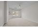 Cozy carpeted bedroom with natural light from a window and a ceiling fan at 2600 Buckingham Dr, Sanford, NC 27330