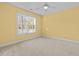 This sunny bedroom has neutral carpet and a ceiling fan at 2600 Buckingham Dr, Sanford, NC 27330