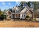 Beautiful two-story home with stone and siding, a well-maintained lawn, and mature trees at 2600 Buckingham Dr, Sanford, NC 27330