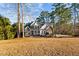 Inviting two-story home with stone accents, black shutters, and a well-manicured front yard at 2600 Buckingham Dr, Sanford, NC 27330