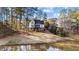 Exterior view of the property from across a pond, showcasing the home's architecture and setting at 2600 Buckingham Dr, Sanford, NC 27330