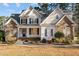 Charming two-story home with stone accents, manicured lawn, and inviting front porch at 2600 Buckingham Dr, Sanford, NC 27330
