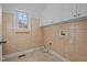 Well-lit laundry room with tile floors and ample storage at 2600 Buckingham Dr, Sanford, NC 27330