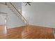 Open living area with hardwood floors, a ceiling fan, and staircase at 2600 Buckingham Dr, Sanford, NC 27330