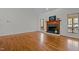 Bright living room featuring hardwood floors, a fireplace, and ample natural light from large windows at 2600 Buckingham Dr, Sanford, NC 27330