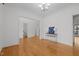 Spacious living room with hardwood floors and an elegant chandelier, providing a welcoming atmosphere at 2600 Buckingham Dr, Sanford, NC 27330
