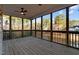 This screened porch features a beautiful view, wood flooring and a ceiling fan at 2600 Buckingham Dr, Sanford, NC 27330