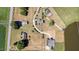 Aerial view of multiple homes with ponds, outbuildings and well-manicured lawns, showcasing the vast property at 2609 Pleasant Hill Liberty Rd, Liberty, NC 27298