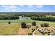 Expansive property featuring a picturesque pond, lush greenery, and inviting residences at 2609 Pleasant Hill Liberty Rd, Liberty, NC 27298