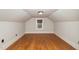 Bright attic with wood floors and a window offering natural light at 2609 Pleasant Hill Liberty Rd, Liberty, NC 27298