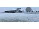 Snowy farm landscape featuring a large wooden barn and fences dusted with snow at 2609 Pleasant Hill Liberty Rd, Liberty, NC 27298