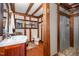 A rustic bathroom with a stylish sink, mirror, toilet, and glass enclosed shower at 2609 Pleasant Hill Liberty Rd, Liberty, NC 27298