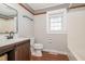 Well-lit bathroom with a modern vanity, toilet, and shower/tub combo at 2609 Pleasant Hill Liberty Rd, Liberty, NC 27298