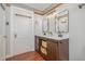 Bathroom featuring a double sink vanity, wood cabinets, and wood floors at 2609 Pleasant Hill Liberty Rd, Liberty, NC 27298
