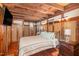 Comfortable bedroom featuring exposed wood beams, accents, and a flat screen tv at 2609 Pleasant Hill Liberty Rd, Liberty, NC 27298