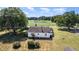 Aerial view showcasing the home, expansive yard and private pond with beautiful countryside at 2609 Pleasant Hill Liberty Rd, Liberty, NC 27298