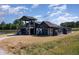 Exterior view of the property featuring unique architectural design and pond access at 2609 Pleasant Hill Liberty Rd, Liberty, NC 27298