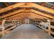 Spacious interior view of a barn featuring wooden beams and natural light at 2609 Pleasant Hill Liberty Rd, Liberty, NC 27298