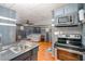Open kitchen with stainless appliances and an adjacent living room at 2609 Pleasant Hill Liberty Rd, Liberty, NC 27298