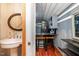Charming kitchenette with a mini-fridge, bar seating, and rustic wood paneling at 2609 Pleasant Hill Liberty Rd, Liberty, NC 27298